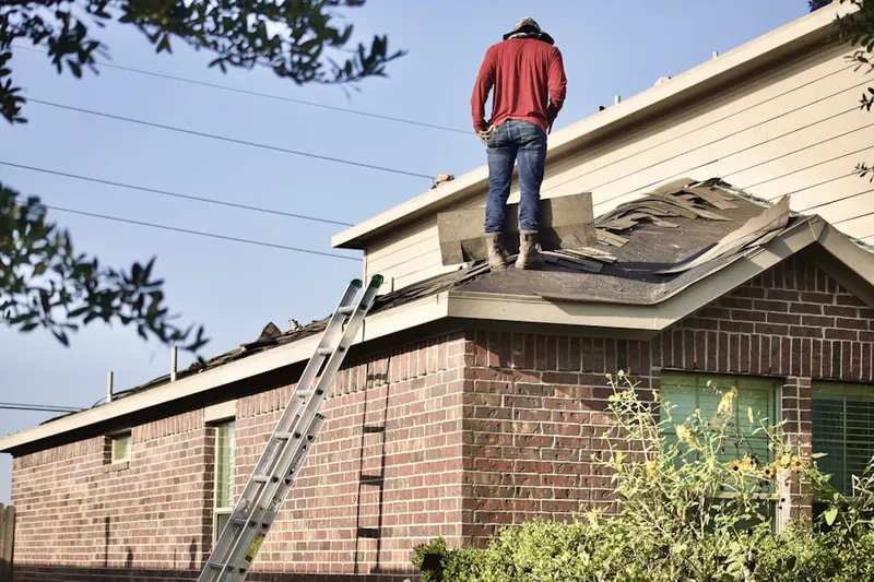 Professional roofer working on a residential roof in Highland Ridge